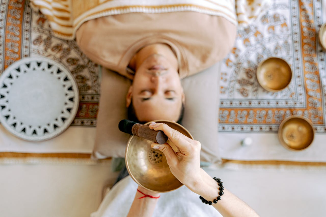 Man lying back with eyes closed, deeply relaxed during a calming Reiki energy healing session